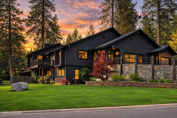 a front view of a house with a garden and plants