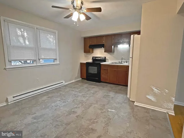 a large kitchen with a stove and a refrigerator