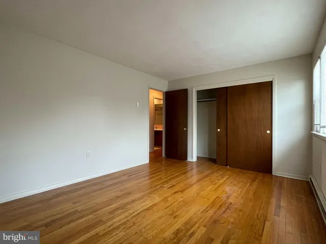 a view of an empty room and wooden floor