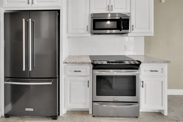 a kitchen with stainless steel appliances wooden cabinets and a stove