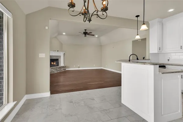 a view of a kitchen with a sink and chandelier