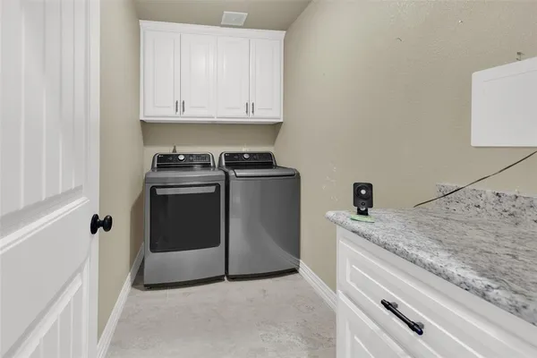 a kitchen with granite countertop white cabinets and white appliances