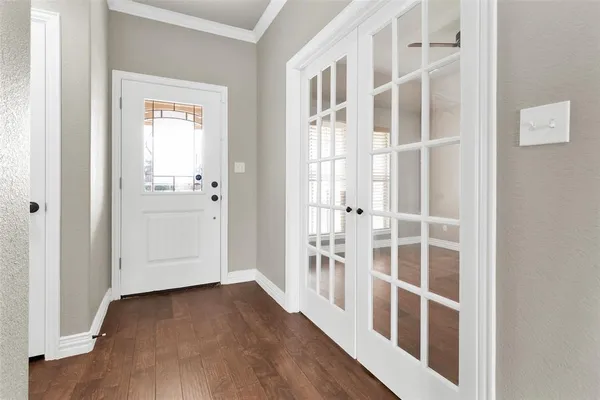 a view of an entryway with wooden floor and windows