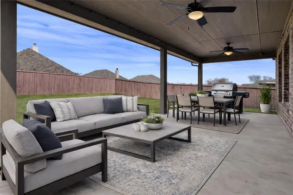a living room with furniture a table and chairs