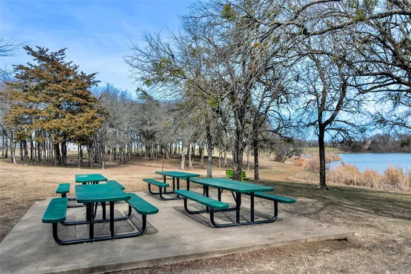 a backyard of a house with table and chairs