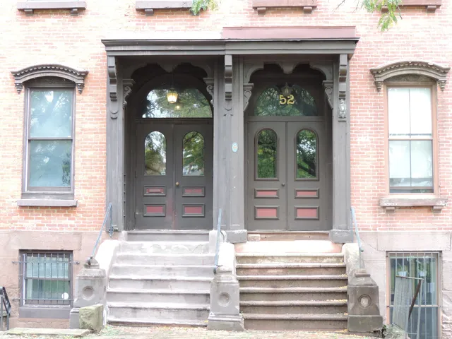 front view of a house with a tree