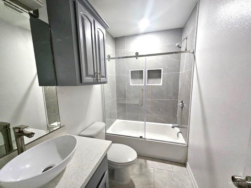 6720 North 4th Street McAllen, TX 78504 - Photo 12 of 25 a bathroom with a sink toilet and shower