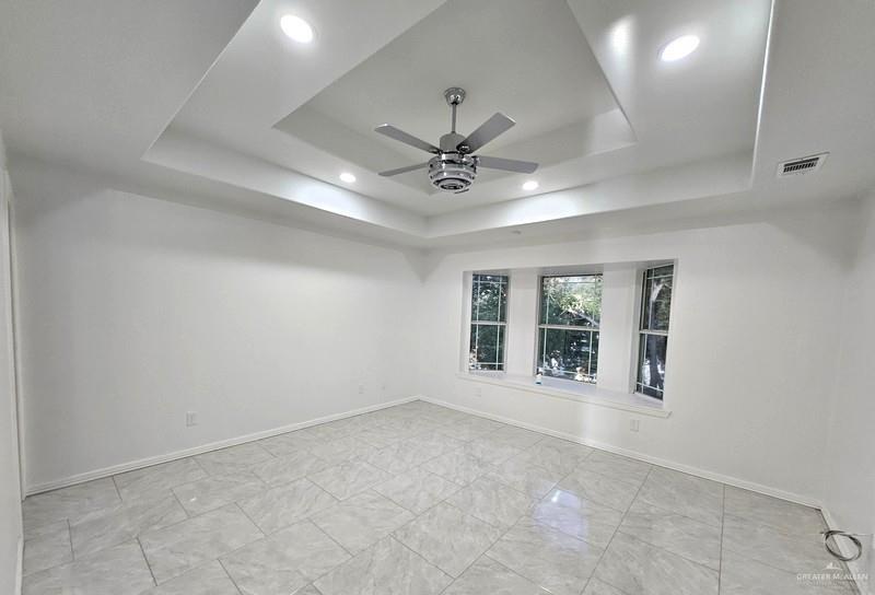 6720 North 4th Street McAllen, TX 78504 - Photo 13 of 25 an empty room with windows and ceiling fan