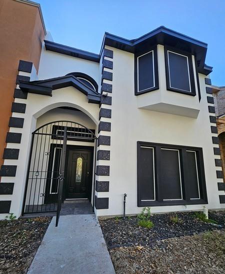 6720 North 4th Street McAllen, TX 78504 - Photo 2 of 25 a front view of a house with garden