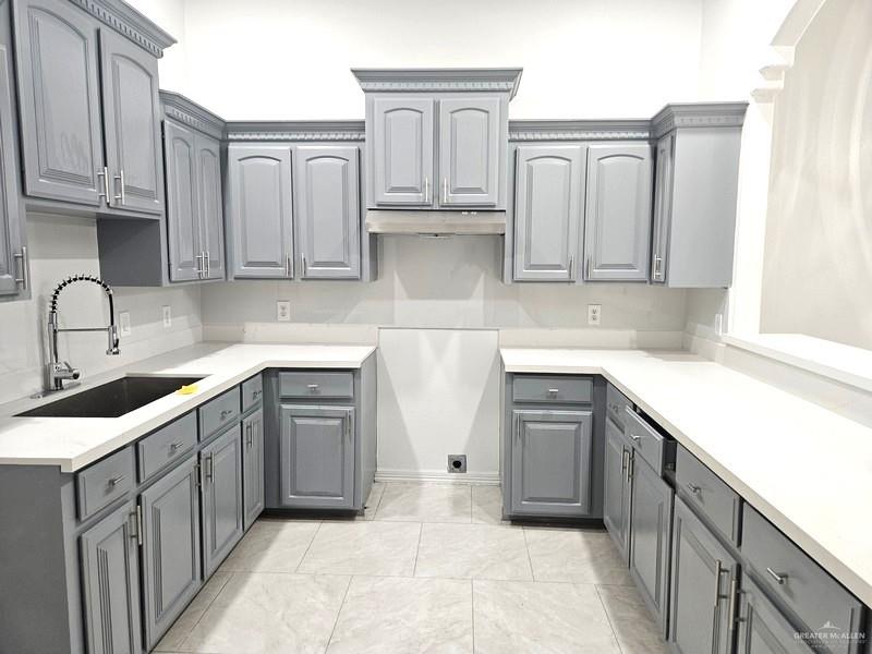 6720 North 4th Street McAllen, TX 78504 - Photo 9 of 25 a kitchen with granite countertop white cabinets and stainless steel appliances