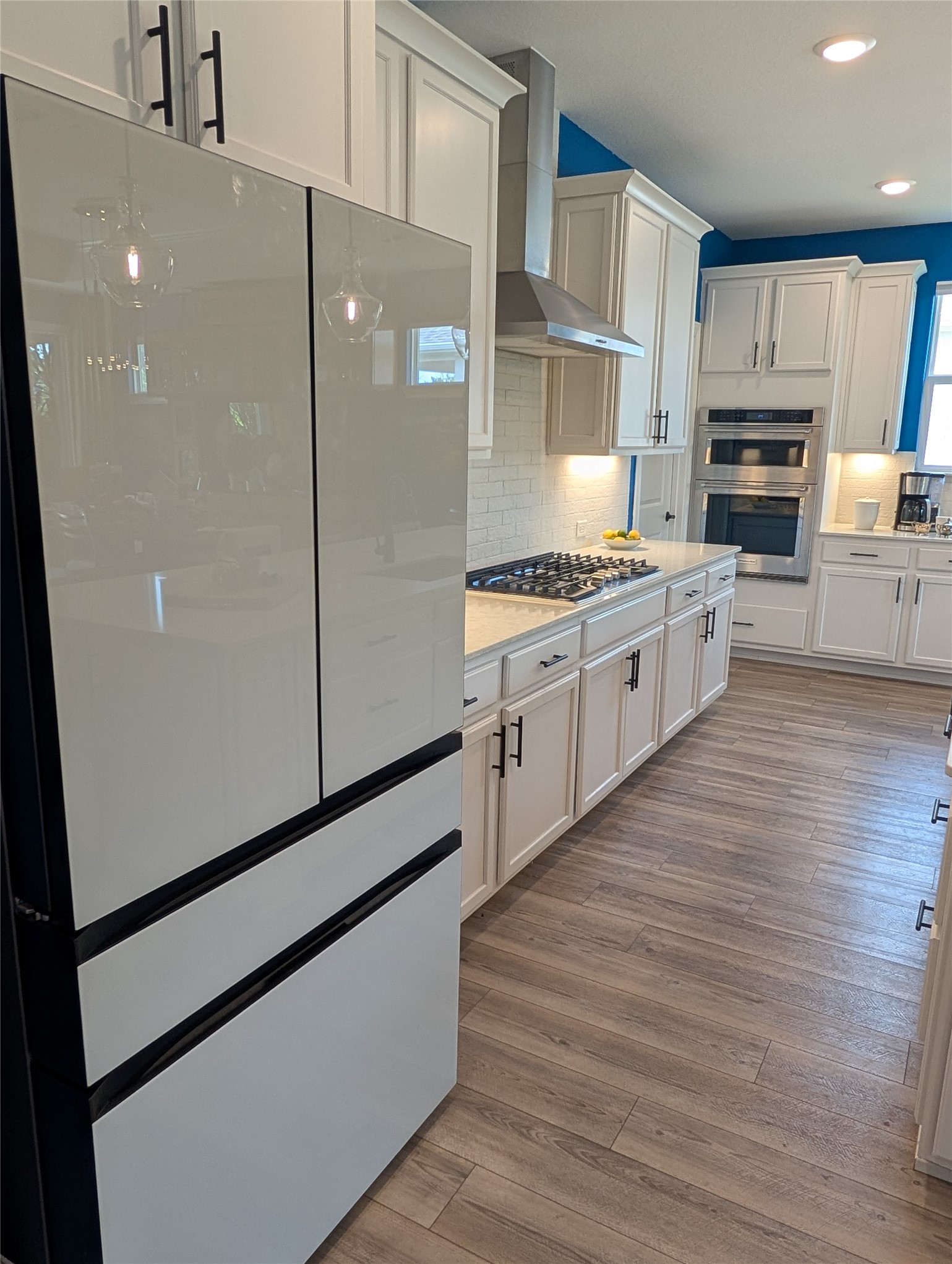 336 Kitty Hawk Road Georgetown, TX 78633 - Photo 12 of 40 Recessed lighting illuminates this modern culinary space featuring hardwood floors and clean-lined cabinetry.