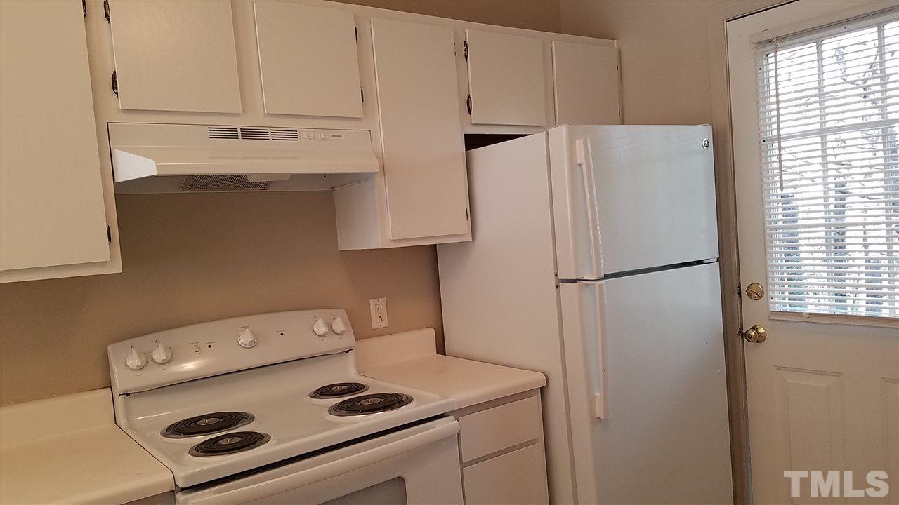 4238 Kaplan Drive Raleigh, NC 27606 - Photo 11 of 21 a kitchen with a refrigerator and a stove