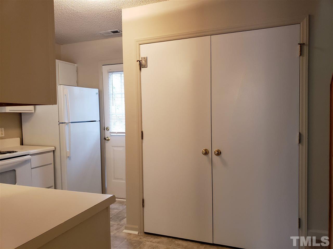 4238 Kaplan Drive Raleigh, NC 27606 - Photo 12 of 21 a kitchen with a refrigerator and a sink