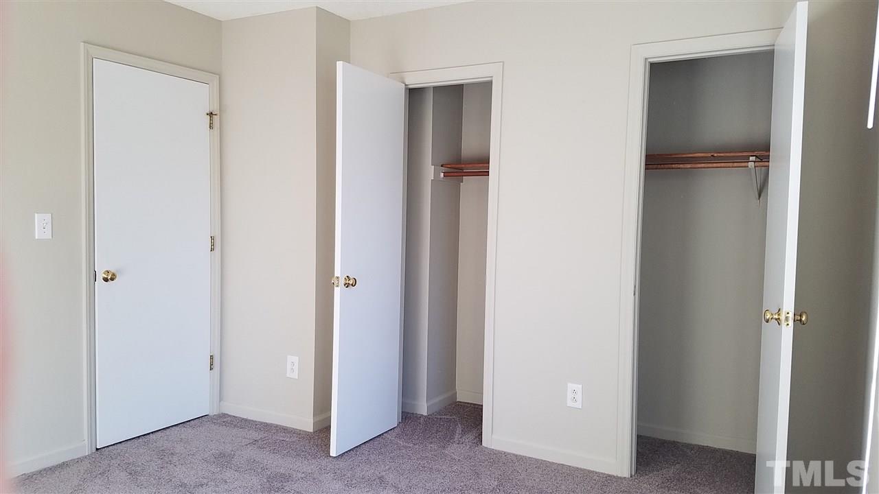 4238 Kaplan Drive Raleigh, NC 27606 - Photo 17 of 21 a view of an empty room with closet and wooden door