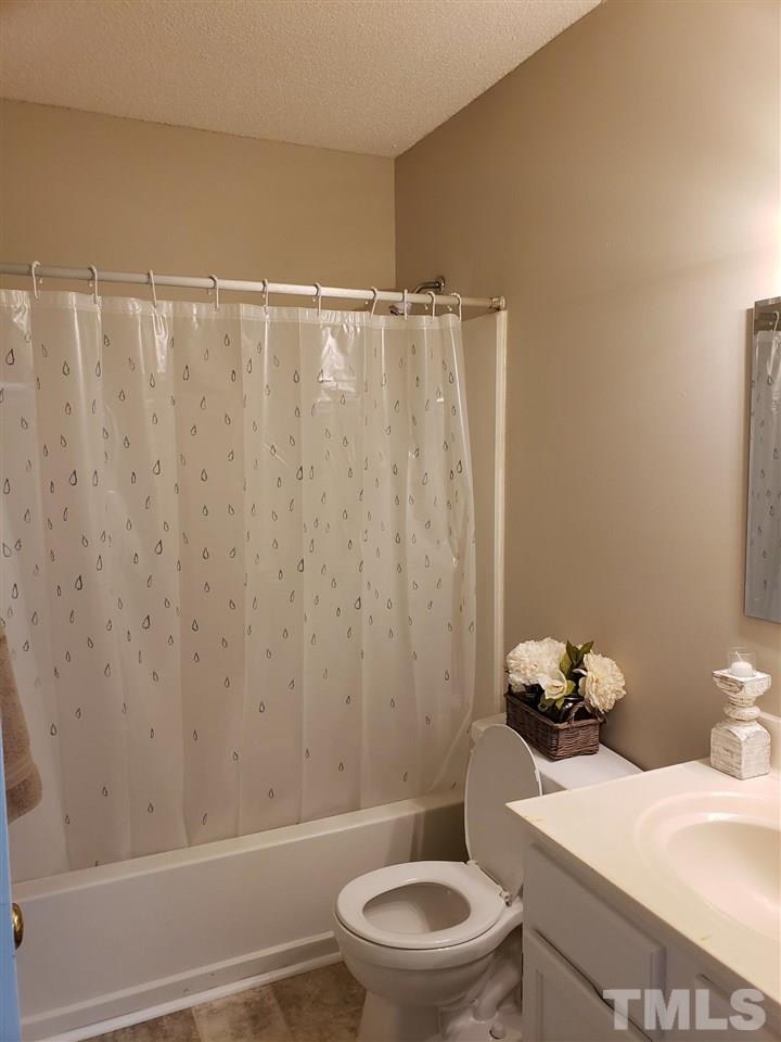 4238 Kaplan Drive Raleigh, NC 27606 - Photo 19 of 21 a bathroom with a sink a toilet and a shower