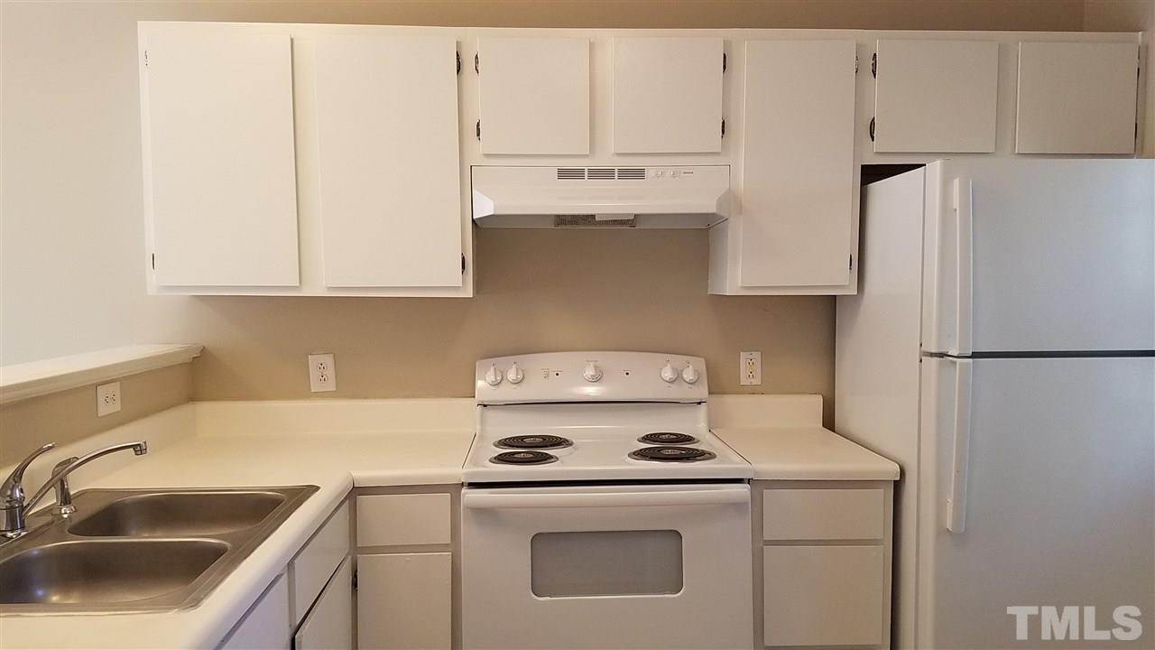 4238 Kaplan Drive Raleigh, NC 27606 - Photo 10 of 21 a kitchen with a sink a stove and refrigerator
