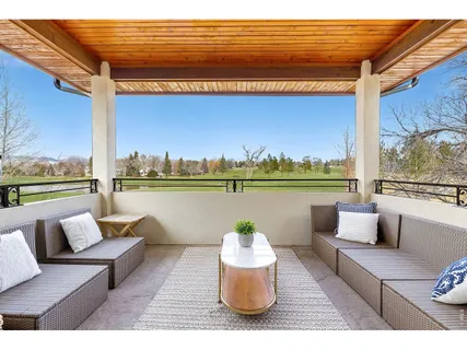 a terrace with outdoor seating and water view
