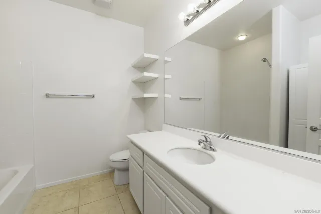 a bathroom with a bath tub with a shower