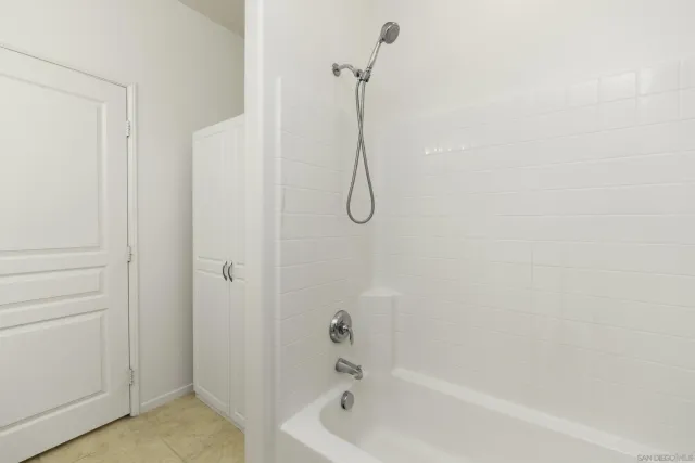 a bathroom with a double vanity sink mirror and shower