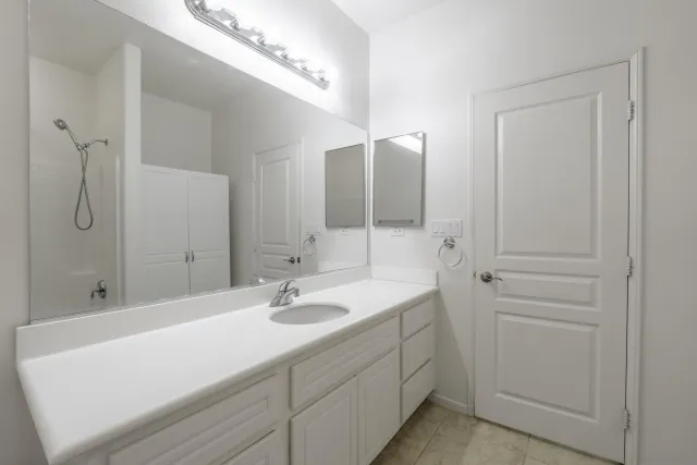 an empty room with a chandelier fan