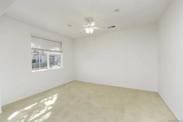 an empty room with a empty space and windows