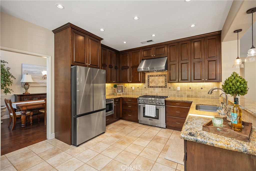 27 Hawk Hill Mission Viejo, CA 92692 - Photo 13 of 48 a kitchen with granite countertop stainless steel appliances a refrigerator and a stove top oven