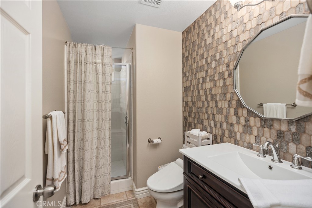 27 Hawk Hill Mission Viejo, CA 92692 - Photo 24 of 48 a bathroom with a sink a toilet and shower