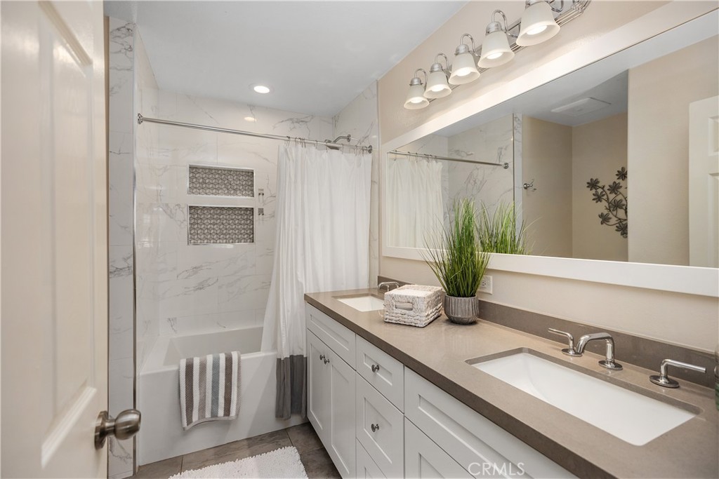 27 Hawk Hill Mission Viejo, CA 92692 - Photo 28 of 48 a bathroom with a double vanity sink and a mirror