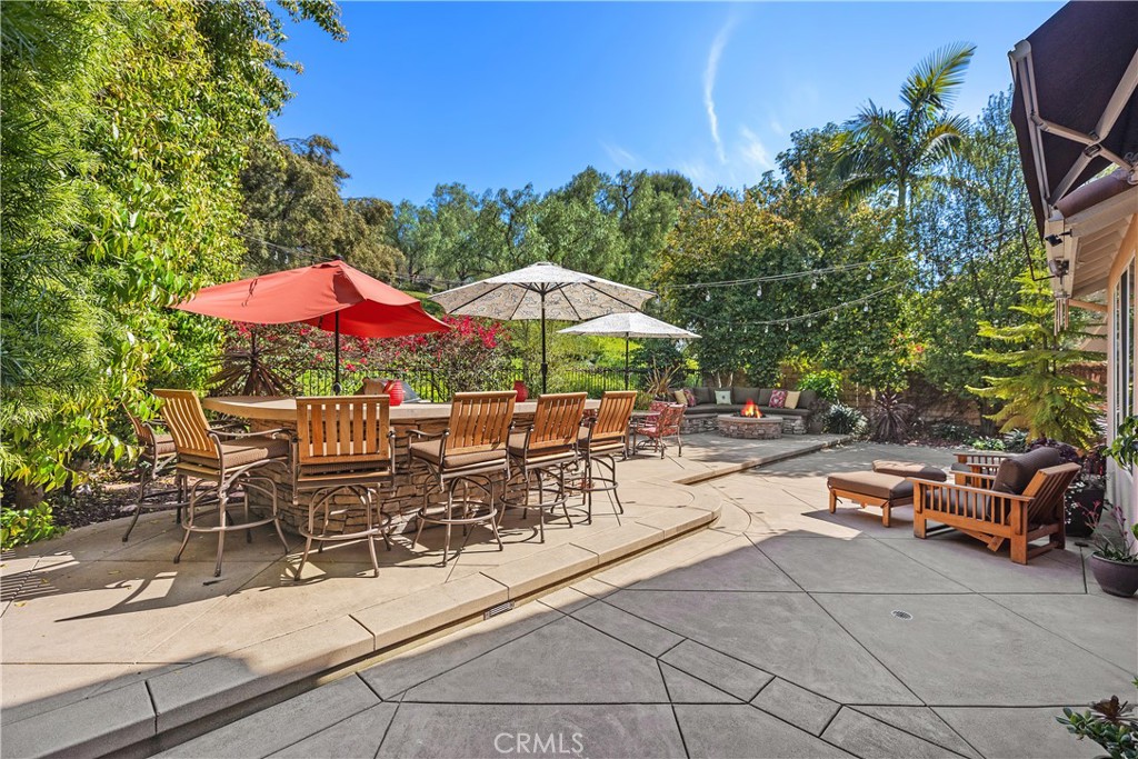 27 Hawk Hill Mission Viejo, CA 92692 - Photo 34 of 48 a view of a patio with a table and chairs under an umbrella