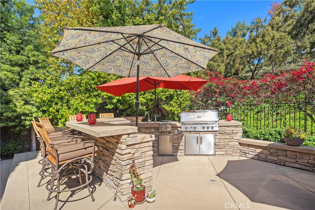 27 Hawk Hill Mission Viejo, CA 92692 - Photo 35 of 48 a view of a patio with a table and chairs under an umbrella