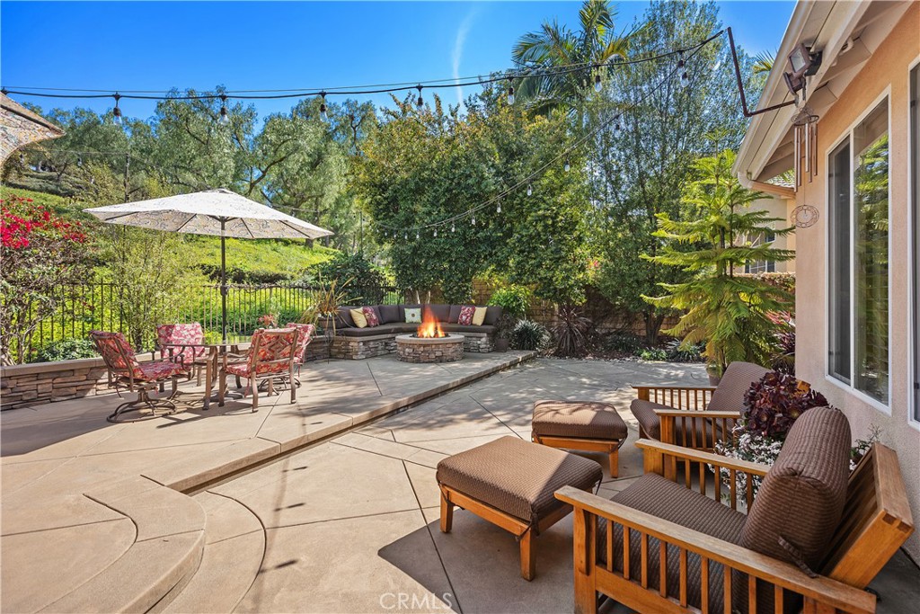 27 Hawk Hill Mission Viejo, CA 92692 - Photo 36 of 48 a view of a patio with a table and chairs under an umbrella