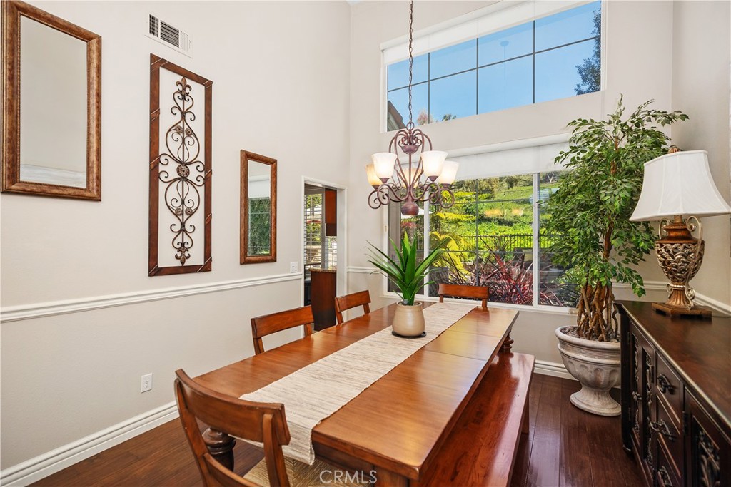 27 Hawk Hill Mission Viejo, CA 92692 - Photo 10 of 48 a view of a dining room with furniture a potted plant and wooden floor