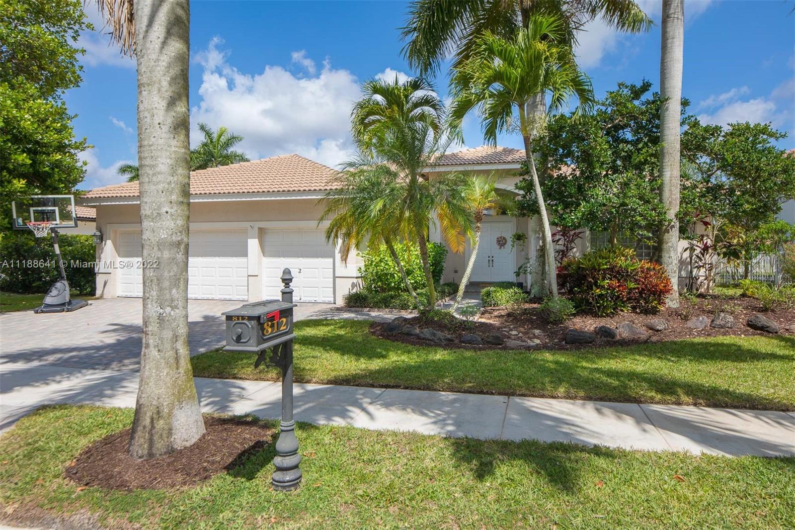 812 Regal Cove Road Weston, FL 33327 - Photo 11 of 64 a view of a palm trees in front of a house