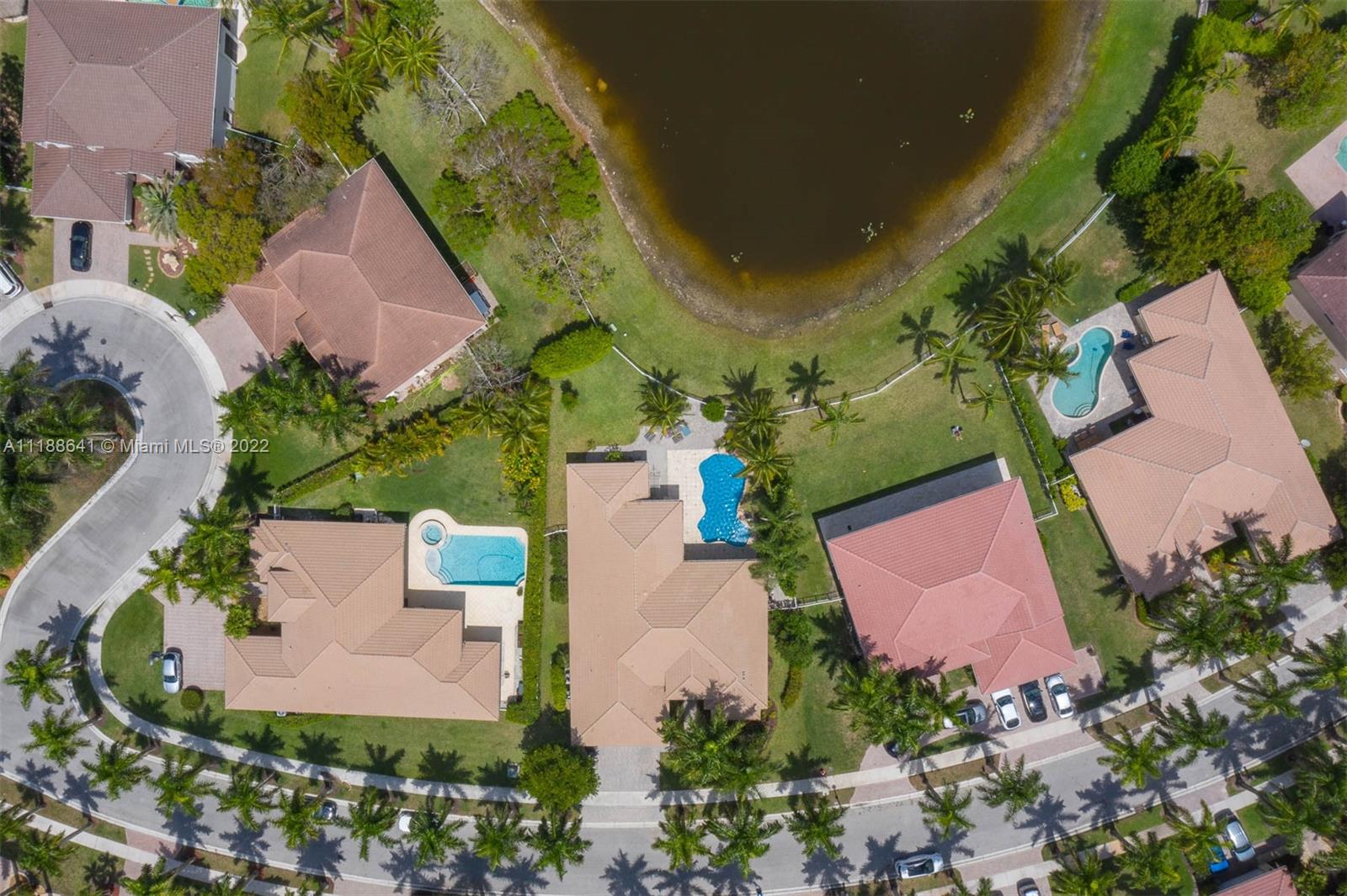 812 Regal Cove Road Weston, FL 33327 - Photo 26 of 64 an aerial view of a house with a garden and swimming pool
