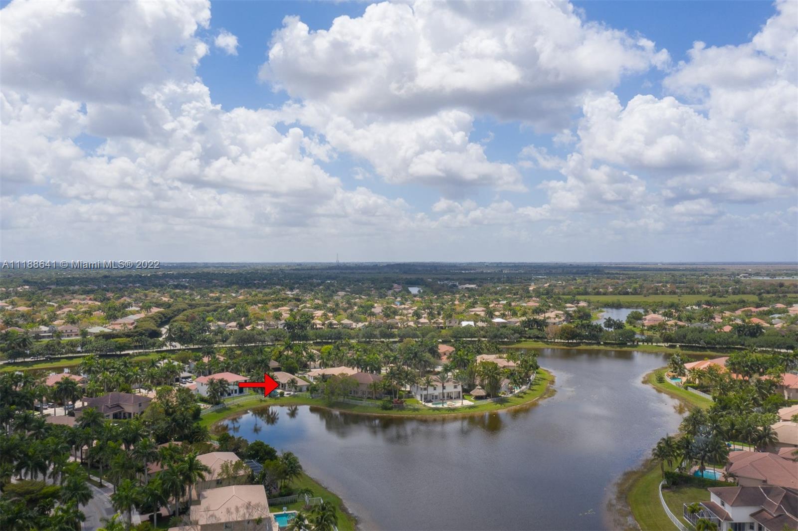 812 Regal Cove Road Weston, FL 33327 - Photo 27 of 64 a view of a lake with houses