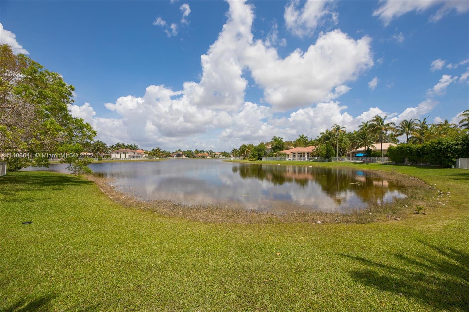 812 Regal Cove Road Weston, FL 33327 - Photo 29 of 64 a view of a lake with houses in the background