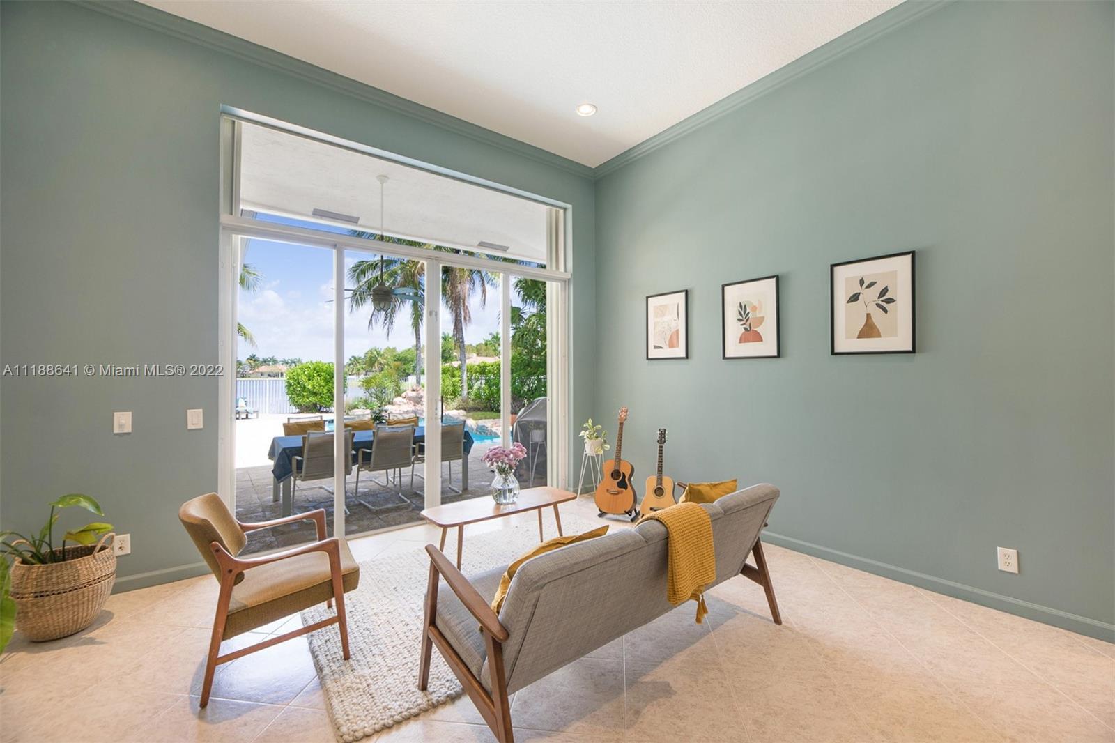 812 Regal Cove Road Weston, FL 33327 - Photo 34 of 64 a living room with furniture and a potted plant