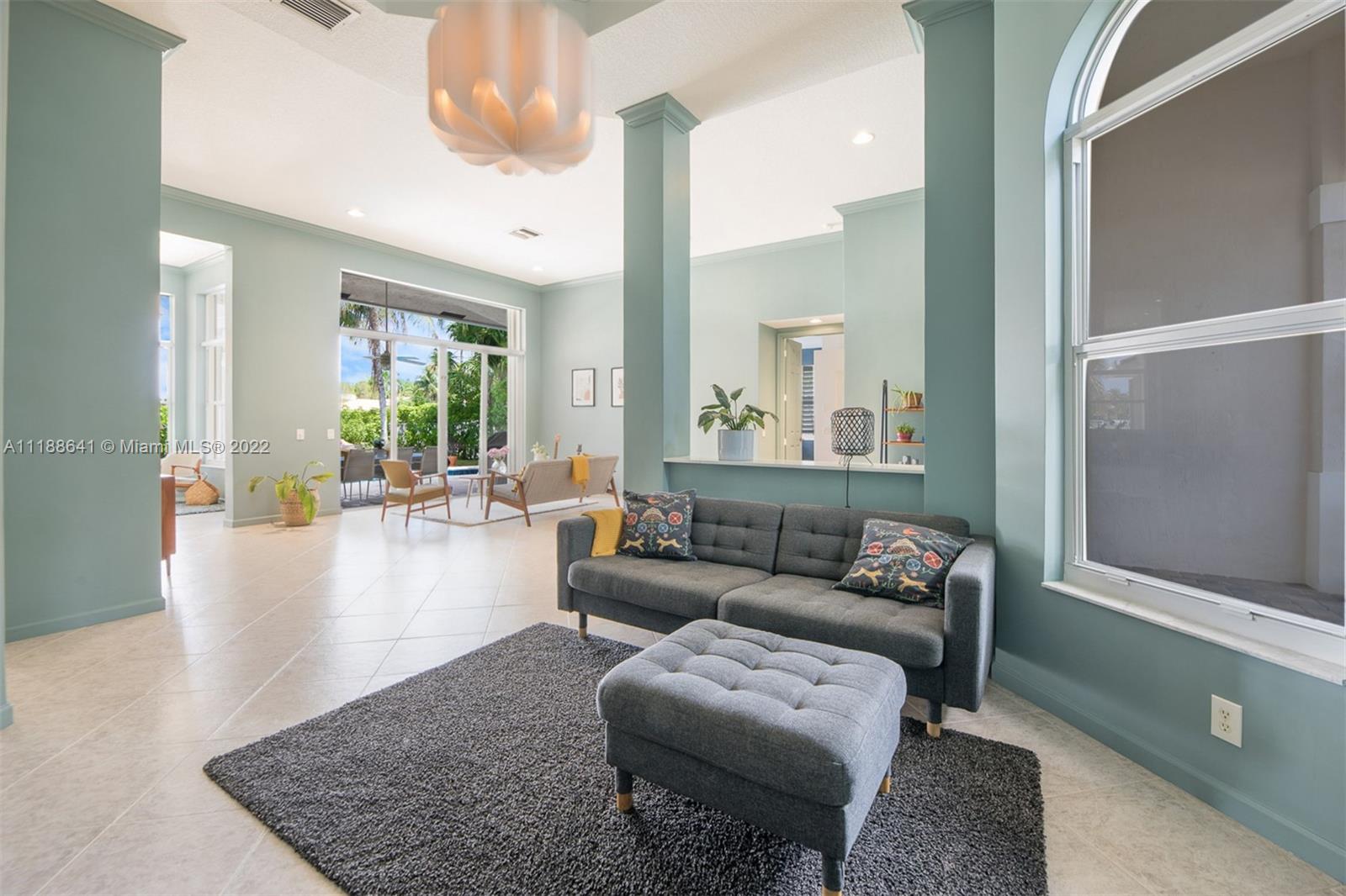 812 Regal Cove Road Weston, FL 33327 - Photo 35 of 64 a living room with furniture and a large window