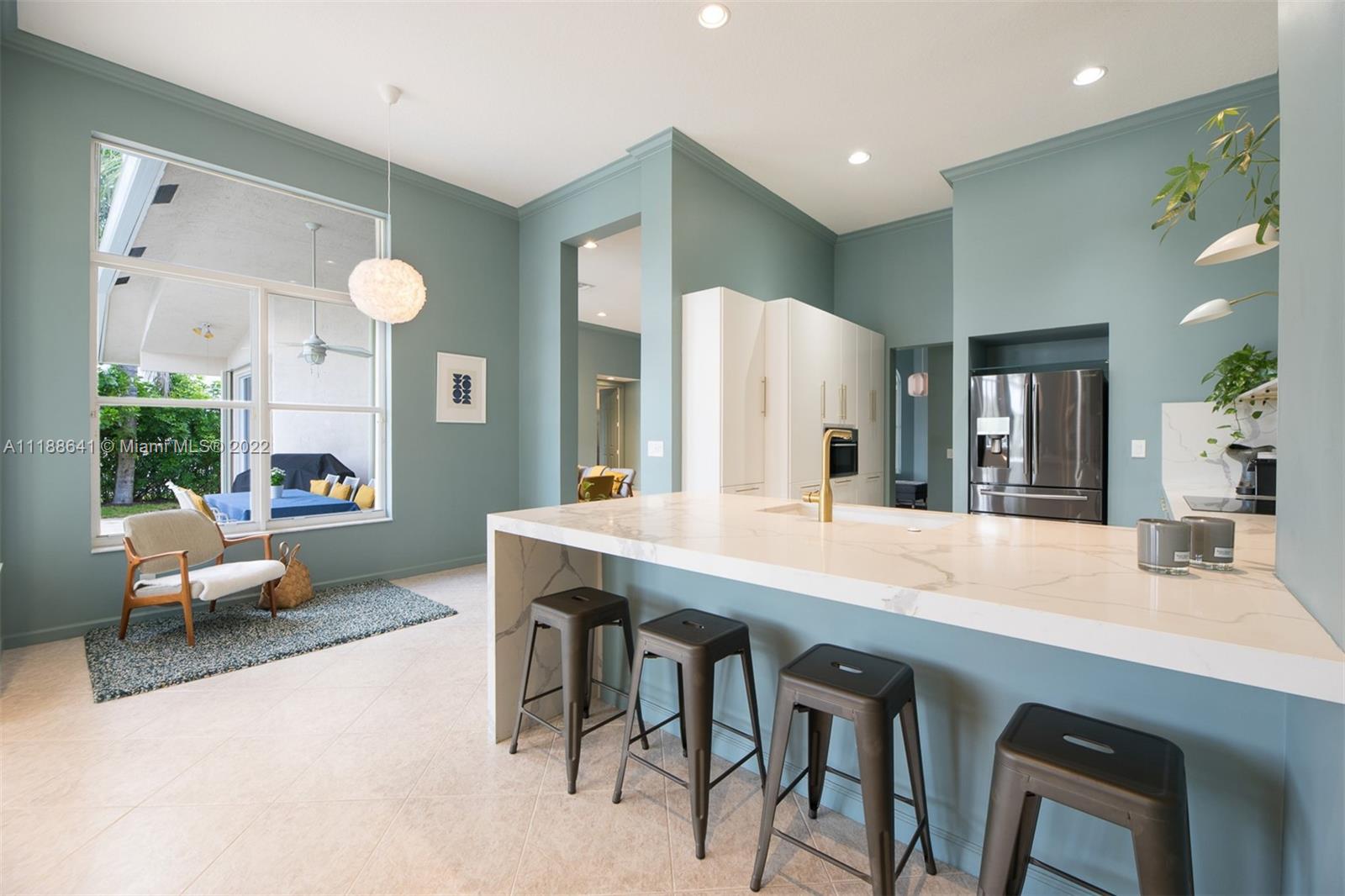 812 Regal Cove Road Weston, FL 33327 - Photo 38 of 64 a kitchen with a table and chairs in it