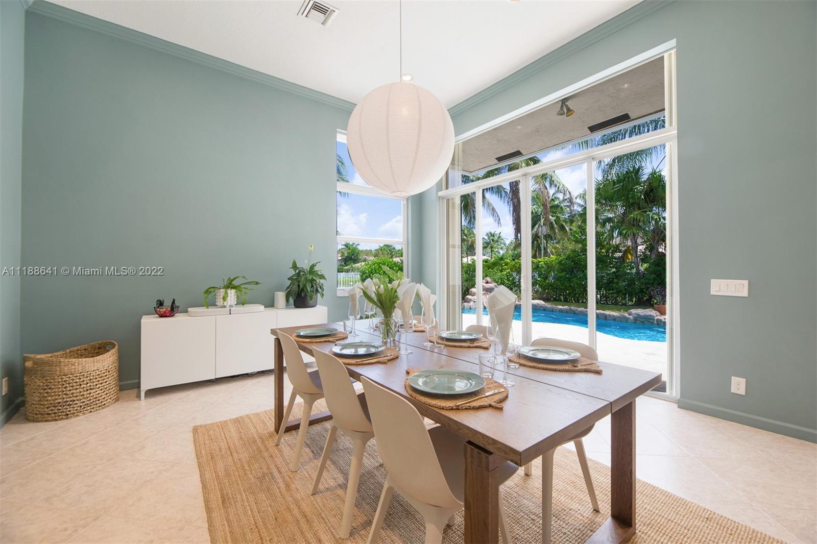 812 Regal Cove Road Weston, FL 33327 - Photo 41 of 64 a dining room with furniture a chandelier and wooden floor