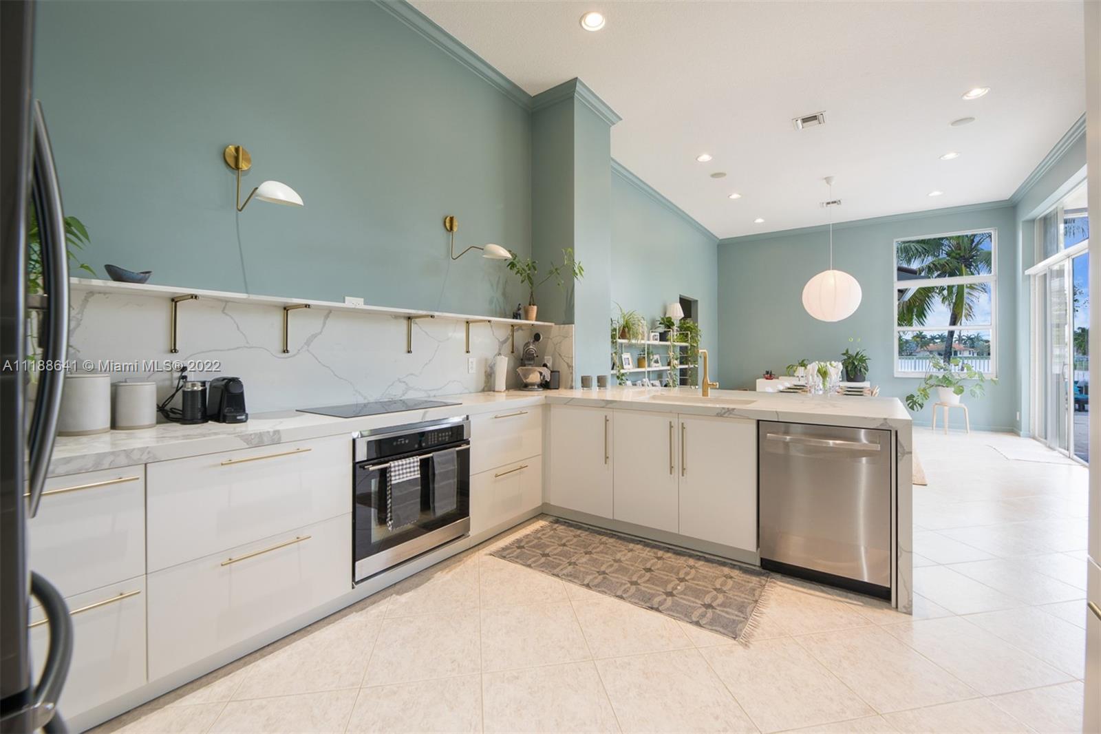 812 Regal Cove Road Weston, FL 33327 - Photo 45 of 64 a kitchen with a sink stove and cabinets