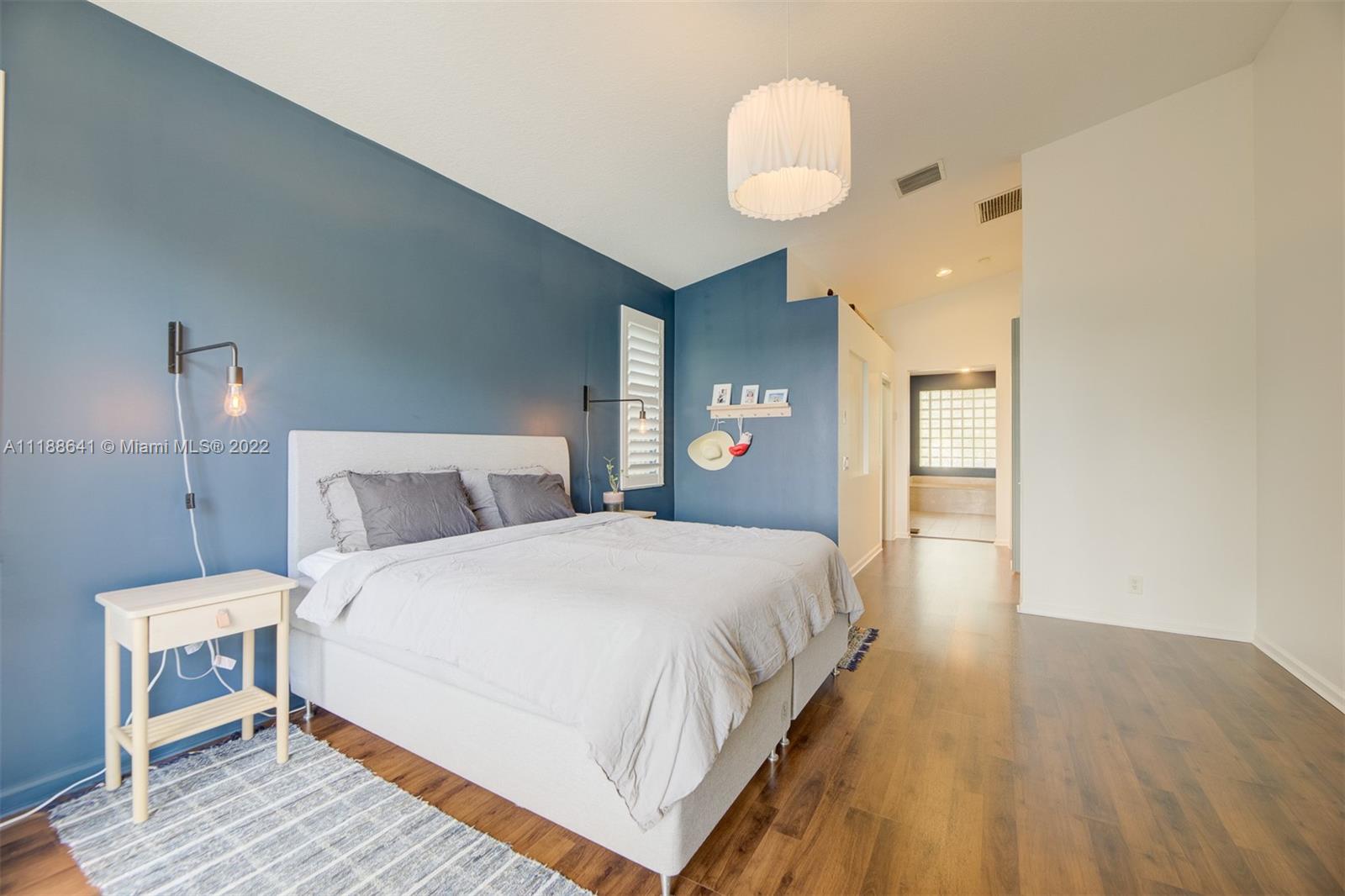 812 Regal Cove Road Weston, FL 33327 - Photo 47 of 64 a bedroom with a bed and wooden floor
