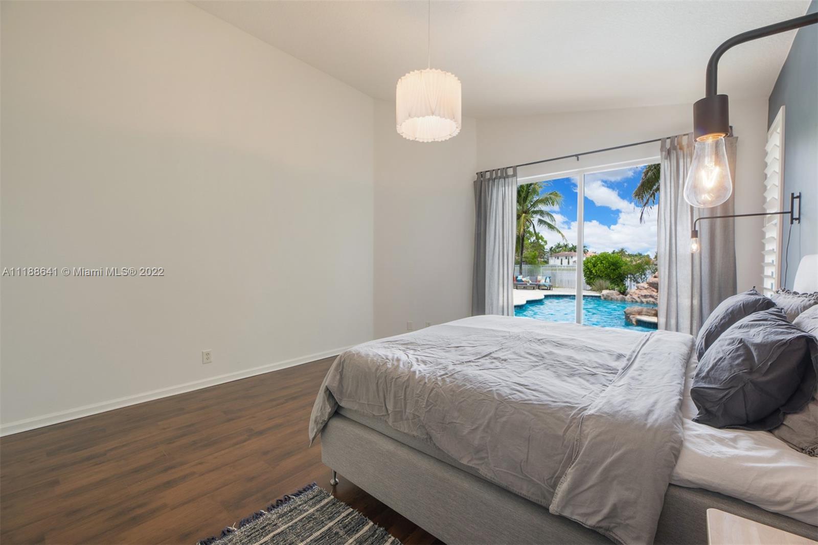 812 Regal Cove Road Weston, FL 33327 - Photo 49 of 64 a bedroom with a bed and a painting on the wall