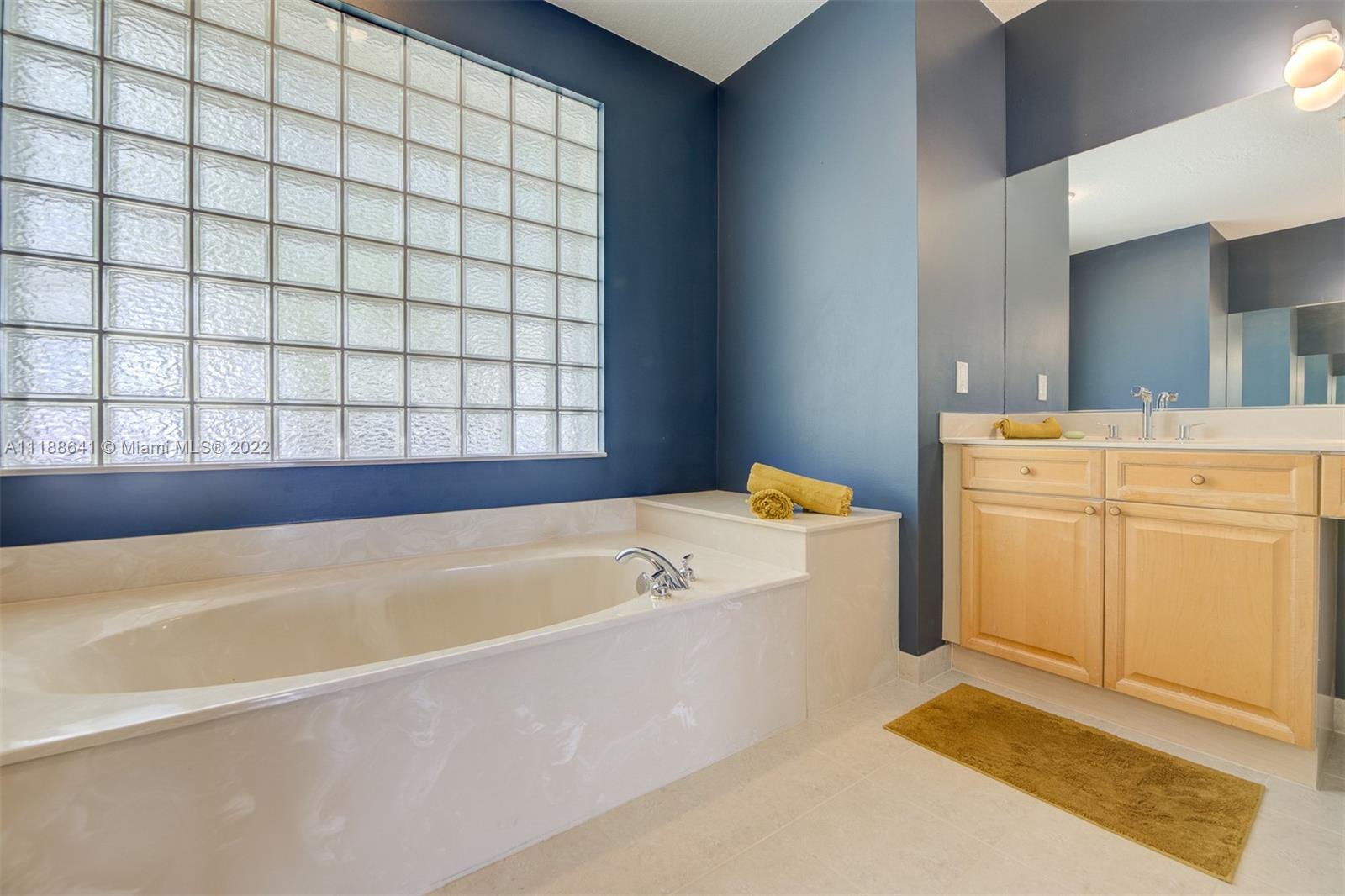 812 Regal Cove Road Weston, FL 33327 - Photo 52 of 64 a bathroom with a bathtub and shower