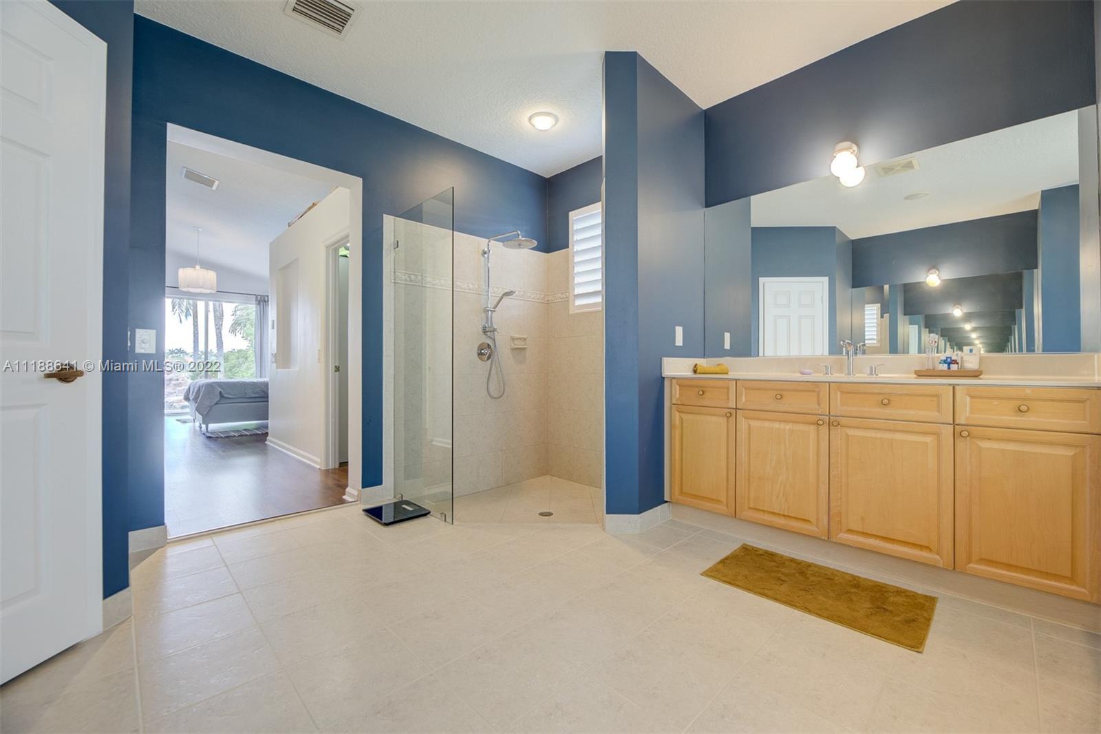 812 Regal Cove Road Weston, FL 33327 - Photo 53 of 64 a view of a hallway with wooden cabinets
