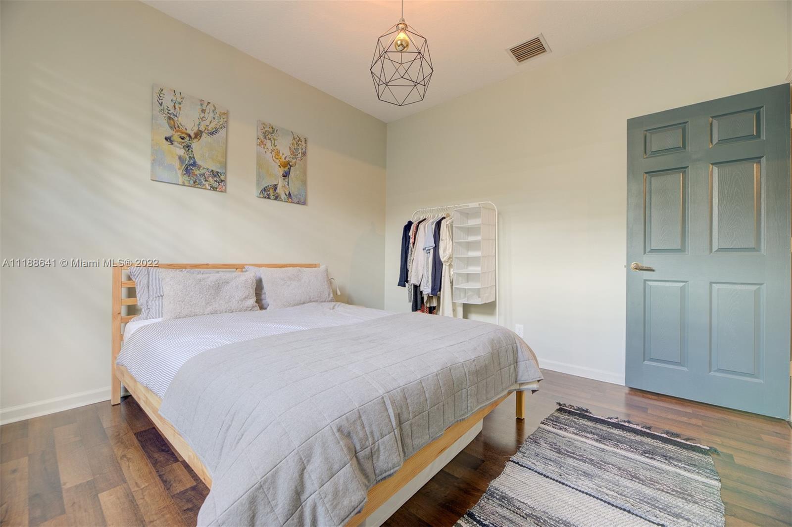 812 Regal Cove Road Weston, FL 33327 - Photo 54 of 64 a bedroom with bed and wooden floor