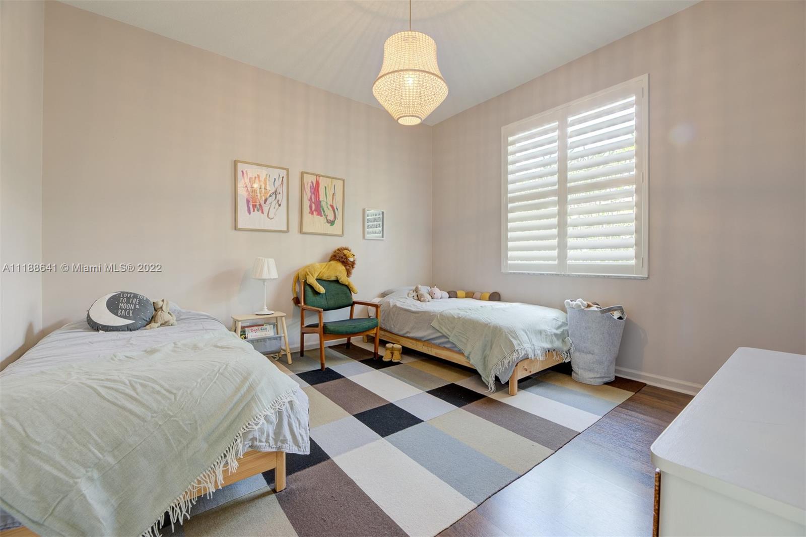 812 Regal Cove Road Weston, FL 33327 - Photo 57 of 64 a bedroom with a bed wooden floor and window