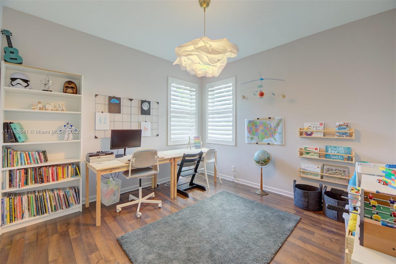 812 Regal Cove Road Weston, FL 33327 - Photo 59 of 64 a view of a workspace with furniture and a book shelf