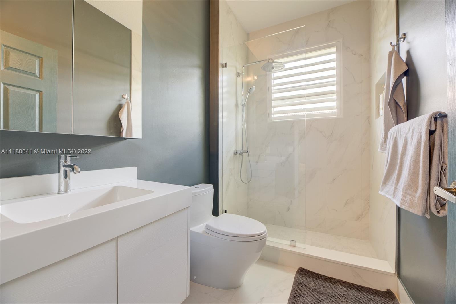 812 Regal Cove Road Weston, FL 33327 - Photo 61 of 64 a bathroom with a sink toilet and shower