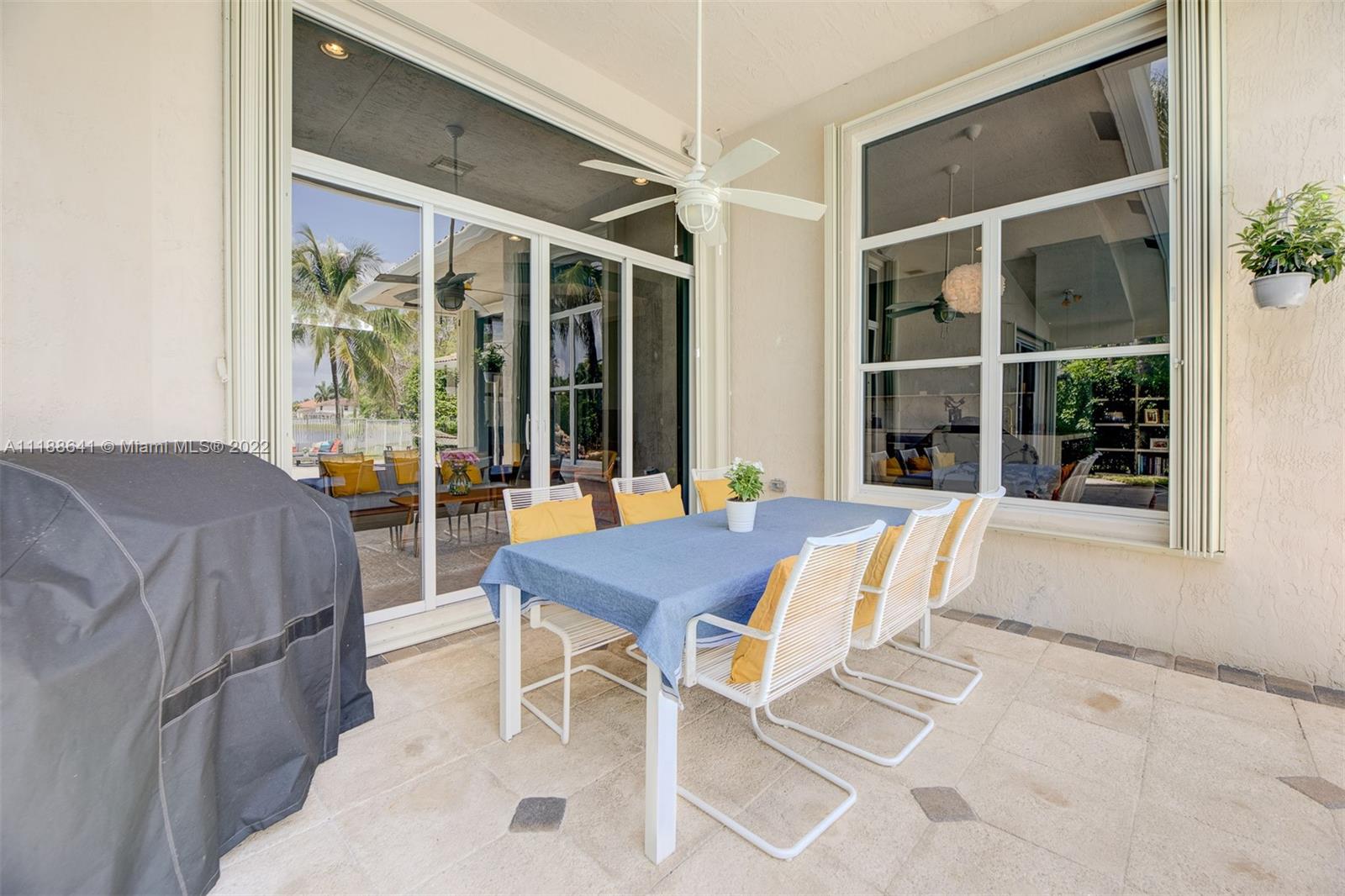 812 Regal Cove Road Weston, FL 33327 - Photo 8 of 64 a view of a patio with table and chairs and potted plants